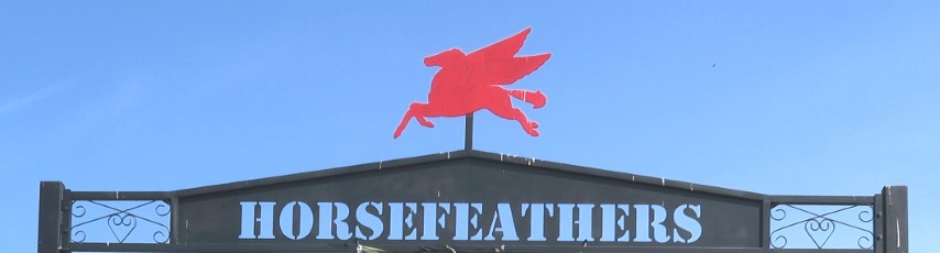 Entrance sign at Horse Feathers